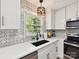 Close up of an updated kitchen with stainless appliances, mosaic backsplash, and updated countertops at 2315 Lawton Bluff Rd, Charlotte, NC 28226