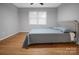Inviting bedroom with hardwood floors, modern ceiling fan, bright window and comfortably made bed at 2502 Gold Rush Dr, Lincolnton, NC 28092