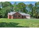 Charming brick home with lush green lawn, mature trees and attached garage at 2502 Gold Rush Dr, Lincolnton, NC 28092