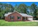 Charming brick home with lush green lawn, mature trees and attached garage at 2502 Gold Rush Dr, Lincolnton, NC 28092