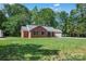 Beautiful brick home with a lush green lawn and mature trees at 2502 Gold Rush Dr, Lincolnton, NC 28092