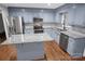 Spacious kitchen boasts stainless steel appliances, granite countertops, blue cabinets, and hardwood floors at 2502 Gold Rush Dr, Lincolnton, NC 28092