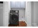 Modern laundry room features updated washer and dryer units, neutral walls, and hardwood floors at 2502 Gold Rush Dr, Lincolnton, NC 28092