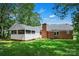 Brick home with a screened porch, chimney and spacious green lawn, perfect for outdoor enjoyment at 2502 Gold Rush Dr, Lincolnton, NC 28092