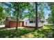 Brick home featuring a screened porch with white trim, lush lawn, and a secluded backyard at 2502 Gold Rush Dr, Lincolnton, NC 28092