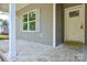 Covered porch featuring gray siding and a door at 2706 Lyla Ave, Concord, NC 28027