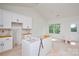 Bright kitchen featuring white cabinets and trim, complemented by a large window at 2706 Lyla Ave, Concord, NC 28027
