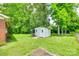 Spacious backyard features a storage shed, mature trees, and lush green grass at 2833 Regency Rd, Lancaster, SC 29720