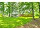Expansive backyard with mature trees providing ample shade and a storage shed at 2833 Regency Rd, Lancaster, SC 29720