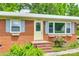Close up of the home's brick facade, light shutters, and well-kept front garden at 2833 Regency Rd, Lancaster, SC 29720