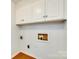 The laundry room has white cabinets providing ample storage above the washer and dryer hookups at 2833 Regency Rd, Lancaster, SC 29720