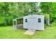Outbuilding with ramp, caged space and door surrounded by mature trees at 2833 Regency Rd, Lancaster, SC 29720