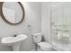 Cozy half-bathroom with a decorative mirror and window providing natural light at 2923 Meadow Creek Ln, Monroe, NC 28110