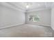 A large bedroom with carpet flooring, crown molding, a ceiling fan, and great natural light at 2923 Meadow Creek Ln, Monroe, NC 28110