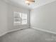 A simple bedroom with a neutral color scheme provides a comfortable and blank canvas at 2923 Meadow Creek Ln, Monroe, NC 28110