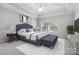 Nicely appointed main bedroom suite with a plush bed, stylish decor, and a ceiling fan at 2923 Meadow Creek Ln, Monroe, NC 28110