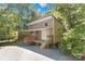 Two-story house surrounded by lush greenery, complemented by a small porch and natural light at 2923 Meadow Creek Ln, Monroe, NC 28110