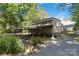 Two-story house elevated on stilts with a covered parking area and lush surrounding greenery at 2923 Meadow Creek Ln, Monroe, NC 28110