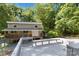 Two-story home nestled among trees with a spacious deck featuring a white railing, with bench at 2923 Meadow Creek Ln, Monroe, NC 28110
