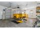 Spacious garage with bright lighting, offering ample space for projects and storage, with car lift at 2923 Meadow Creek Ln, Monroe, NC 28110