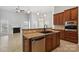 Open floorplan features granite countertops, stainless steel appliances, sink and a fireplace in the living area at 2923 Meadow Creek Ln, Monroe, NC 28110