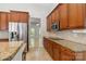 Modern kitchen with granite countertops, tile backsplash, stainless steel appliances and cherry wood cabinetry at 2923 Meadow Creek Ln, Monroe, NC 28110