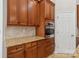 Cherry wood cabinets, stainless steel oven and granite countertops highlight this kitchen at 2923 Meadow Creek Ln, Monroe, NC 28110