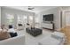 Staged living room showcasing hardwood floors, multiple windows and a ceiling fan at 2923 Meadow Creek Ln, Monroe, NC 28110
