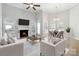 Living room with fireplace, seating, TV, tile floors and a view of a round dining table at 2923 Meadow Creek Ln, Monroe, NC 28110