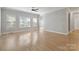 Bright open-concept living room with hardwood floors and multiple windows, ceiling fan at 2923 Meadow Creek Ln, Monroe, NC 28110