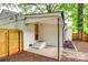 Covered back porch with steps leading to the backyard and a wooden fence at 3120 Parkway Ave, Charlotte, NC 28208