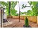 Large backyard featuring a new wooden fence and mature trees, offering a private outdoor space at 3120 Parkway Ave, Charlotte, NC 28208