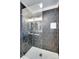 Modern shower with black hexagon tile and glass door, adding luxury to the space at 3120 Parkway Ave, Charlotte, NC 28208