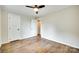 Bedroom featuring a ceiling fan and hardwood floors with a closet and ensuite at 3120 Parkway Ave, Charlotte, NC 28208