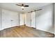 Bedroom features a ceiling fan, with hardwood floors, a closet and a sliding barn door at 3120 Parkway Ave, Charlotte, NC 28208