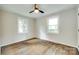 Bedroom features a ceiling fan and hardwood floors with a view to the outdoors at 3120 Parkway Ave, Charlotte, NC 28208