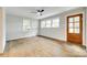 Bonus room with hardwood floors, two windows, neutral walls and a wood-framed glass paneled door at 3120 Parkway Ave, Charlotte, NC 28208
