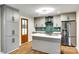 Updated kitchen with gray cabinets, stainless steel appliances and an island with a sink at 3120 Parkway Ave, Charlotte, NC 28208
