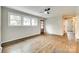 Empty bonus room with hardwood floors, three windows and a wood-framed glass paneled door at 3120 Parkway Ave, Charlotte, NC 28208