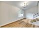 Living Room features a chandelier, hardwood floors, and a view to the outdoors at 3120 Parkway Ave, Charlotte, NC 28208