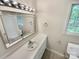 Bathroom features a framed mirror over a white vanity with great natural lighting at 3203 Oakdale Dr, Monroe, NC 28110
