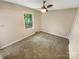 This bedroom has a ceiling fan and natural light from the window at 3203 Oakdale Dr, Monroe, NC 28110