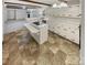 Kitchen features an island cooktop, ample counter space, and abundant white cabinetry at 3203 Oakdale Dr, Monroe, NC 28110
