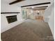 Bright living room features a fireplace, wood beams, and access to the kitchen and outdoor space at 3203 Oakdale Dr, Monroe, NC 28110
