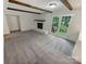 Bright living room with a white brick fireplace, exposed beams, and french doors leading to the outside at 3203 Oakdale Dr, Monroe, NC 28110