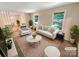 Bright living room features neutral walls, large windows offering nice views, and modern furniture arrangement at 3203 Oakdale Dr, Monroe, NC 28110