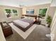 Well-lit main bedroom featuring a large bed, soft carpet, and scenic views from the oversized windows at 3203 Oakdale Dr, Monroe, NC 28110