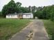Exterior shot of a single-story home featuring a long driveway and outbuilding at 3315 Buffalo Shoals Rd, Newton, NC 28658