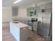 Spacious kitchen featuring gray cabinets, stainless steel appliances, and a functional center island at 3315 Buffalo Shoals Rd, Newton, NC 28658