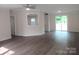 Open-concept living room featuring modern flooring and natural light from sliding glass doors at 3315 Buffalo Shoals Rd, Newton, NC 28658